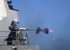 An MK-38 25mm gun system is fired during a live-fire exercise aboard the guided-missile destroyer USS Mason