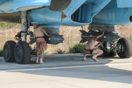 Fixing KAB-500S guided bombs to a Sukhoi Su-34 at Latakia