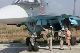 A Russian pilot inspects his Su-34 prior to a mission